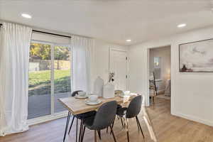 Dining space featuring a textured ceiling and light wood-type flooring