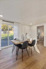 Dining room with a textured ceiling and light hardwood / wood-style floors