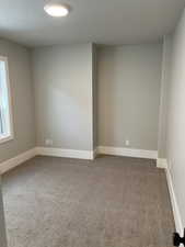 Carpeted spare room with a textured ceiling