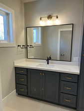 Bathroom featuring vanity, tile patterned floors, and a healthy amount of sunlight