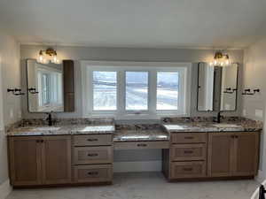 Bathroom with vanity and a textured ceiling