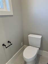 Bathroom featuring tile patterned flooring and toilet