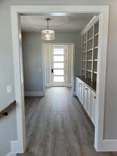 Mudroom featuring a textured ceiling and dark hardwood / wood-style flooring