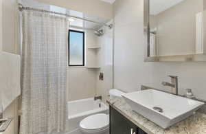 Full bathroom with vanity, toilet, and shower / bath combo