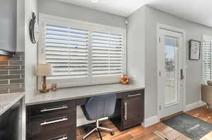 Home office featuring built in desk and light hardwood / wood-style flooring