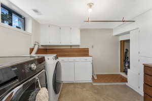 Laundry room with cabinets and independent washer and dryer