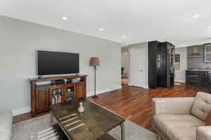 Living room with dark hardwood / wood-style floors