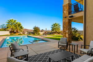 View of pool featuring a mountain view and a patio