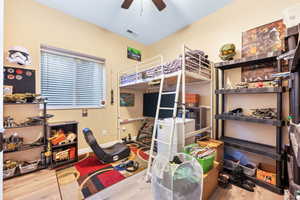 Bedroom featuring wood-type flooring and ceiling fan