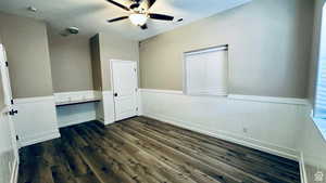 Unfurnished bedroom with dark wood-type flooring and ceiling fan