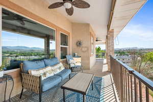 Balcony with an outdoor living space, a mountain view, and ceiling fan