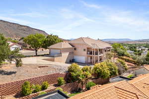 Exterior space with a balcony, a garage, and a mountain view