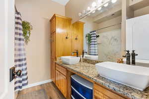 Bathroom with vanity and hardwood / wood-style flooring