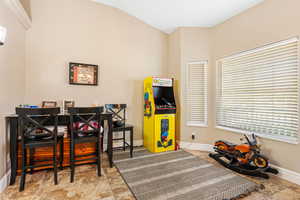 Recreation room featuring lofted ceiling