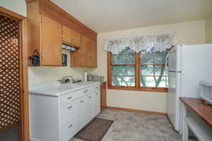 Kitchen featuring white refrigerator