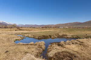 Property view of water featuring a mountain view and a rural view