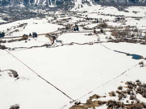 Snowy aerial view featuring a mountain view