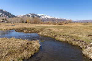 Water view featuring a mountain view and a rural view