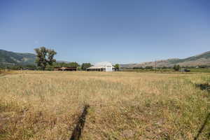 View of yard featuring a rural view and a mountain view