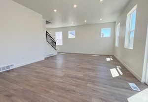 Empty room with light hardwood / wood-style flooring