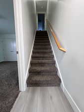 Stairs featuring hardwood / wood-style flooring