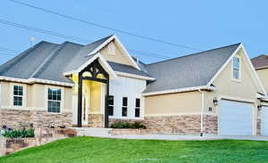 View of front of property featuring a garage and a front yard