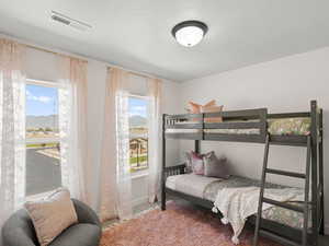 Bedroom with a mountain view and carpet flooring