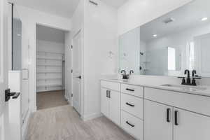 Bathroom featuring vanity and a shower with shower door