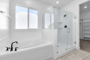 Bathroom with a wealth of natural light and shower with separate bathtub