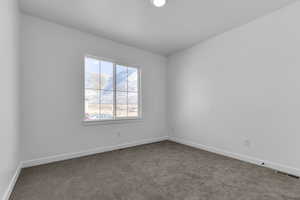 Unfurnished room featuring carpet flooring