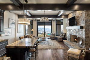 Kitchen with pendant lighting, dark wood-type flooring, a breakfast bar area, wooden counters, and a center island