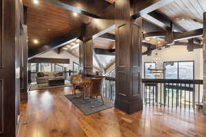 Hall with hardwood / wood-style flooring, high vaulted ceiling, wooden ceiling, and beam ceiling