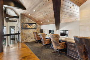 Office space with wood ceiling, built in desk, hardwood / wood-style flooring, and vaulted ceiling with beams