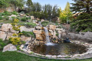 View of yard featuring a small pond