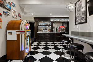 Bar featuring dark brown cabinets