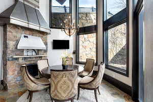 Dining space featuring a towering ceiling and a chandelier