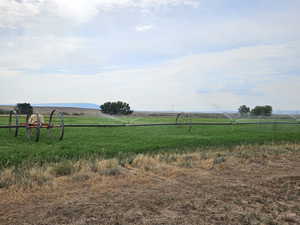 View of pasture with a rural view of farmable land with wheel lines and water.