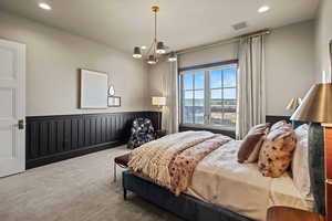 Bedroom with an inviting chandelier and carpet flooring