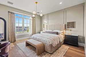 Bedroom featuring a water view and light hardwood / wood-style floors