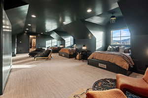 Carpeted bedroom featuring lofted ceiling and a mountain view