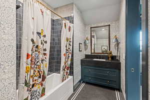 Bathroom featuring vanity and shower / bath combo