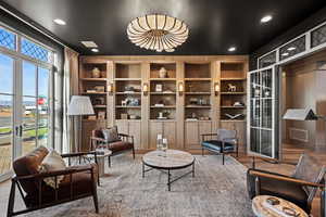 Living area with wood-type flooring and french doors