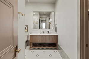 Bathroom featuring tile patterned flooring, vanity, and toilet