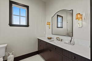 Bathroom featuring vanity and toilet