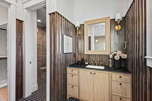 Bathroom with tiled shower and vanity