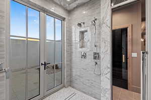 Bathroom featuring tiled shower