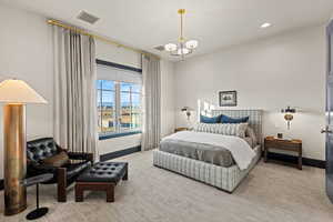 Bedroom featuring light colored carpet and a chandelier