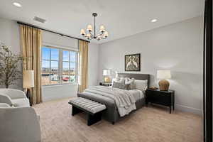 Carpeted bedroom featuring a notable chandelier