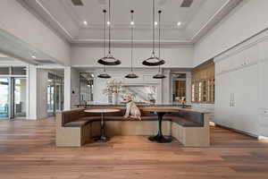 Kitchen featuring crown molding, decorative light fixtures, and a breakfast bar