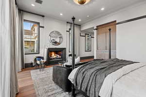 Bedroom with crown molding and light wood-type flooring